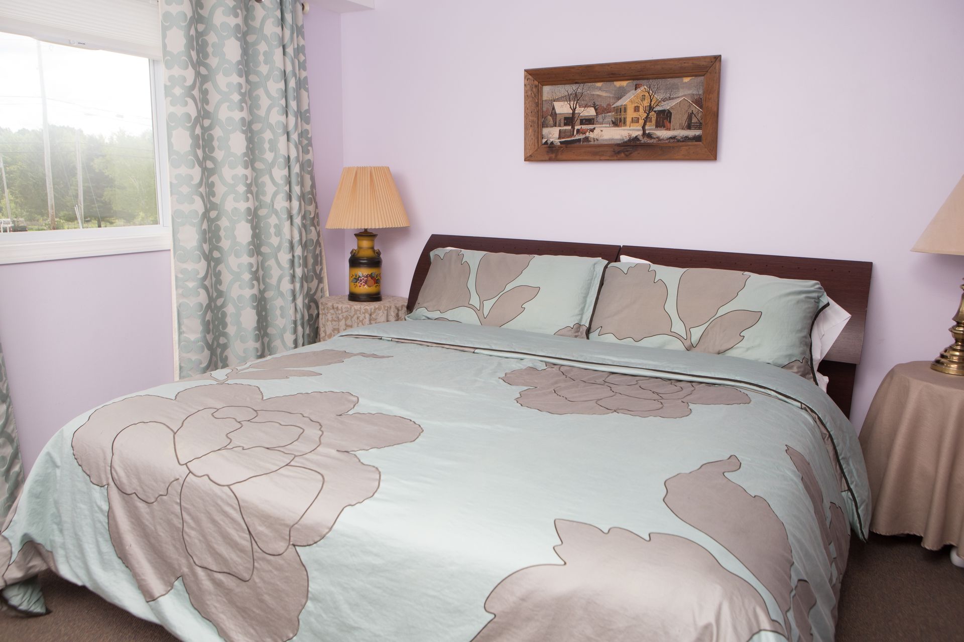 a bedroom with a large bed and two lamps