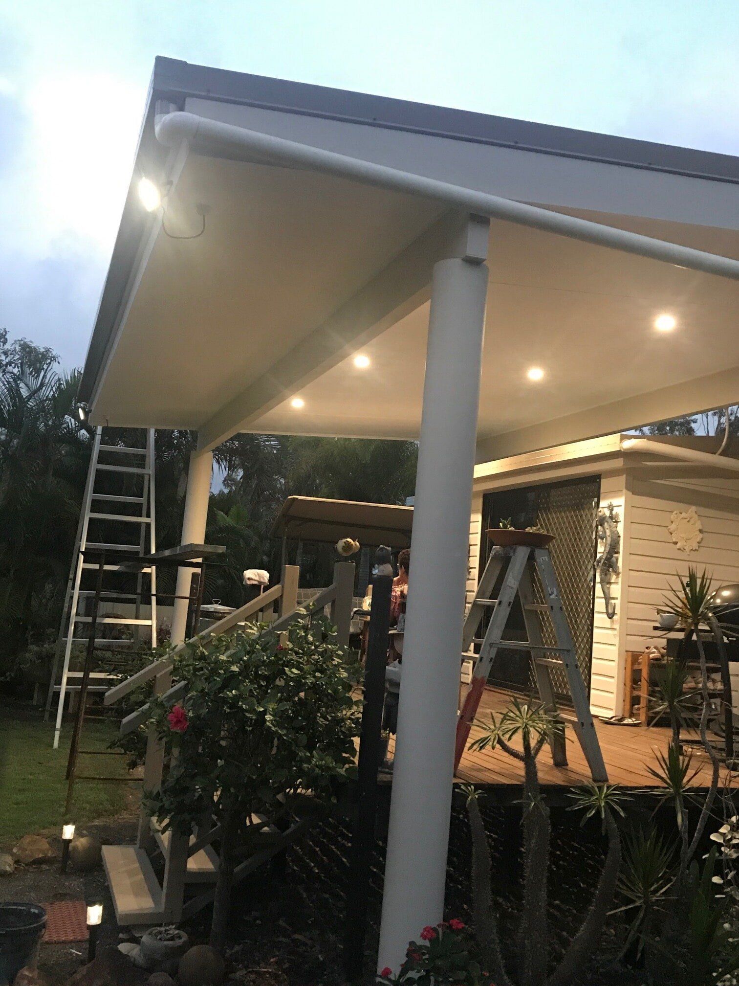A white house with a porch and a ladder in front of it — Building Services in Rockhampton