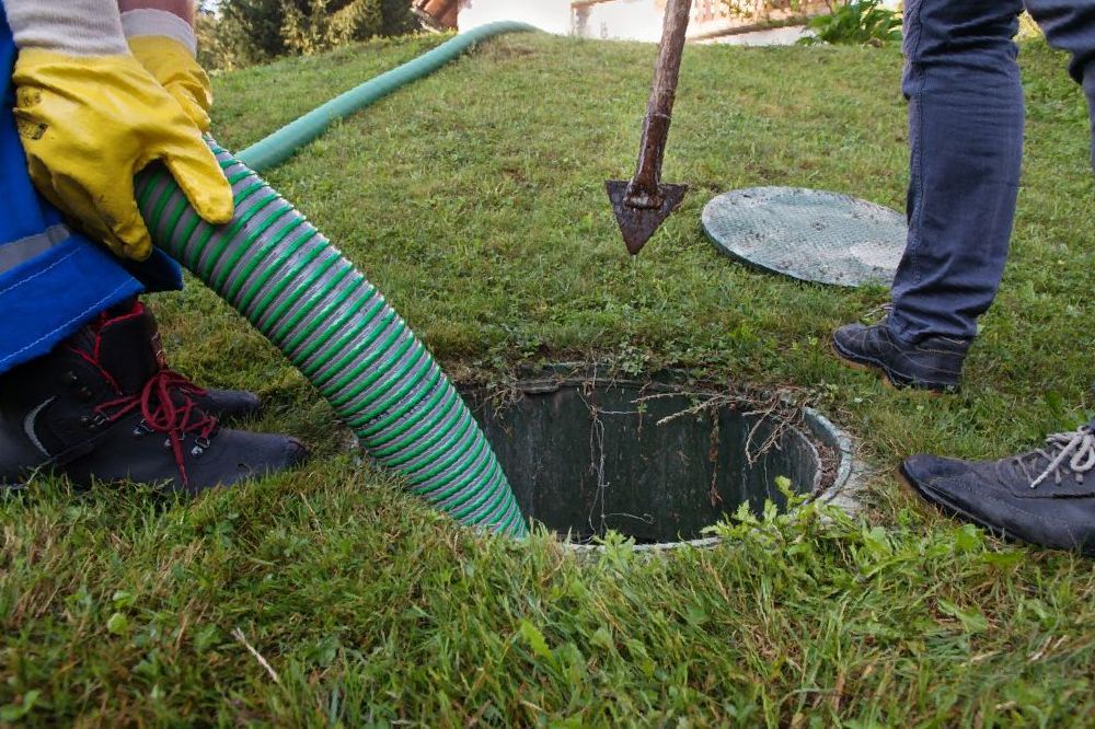 A Manhole Cover is Sitting on Top of a Pile of Dirt — Proserpine Septic Service In Proserpine, QLD