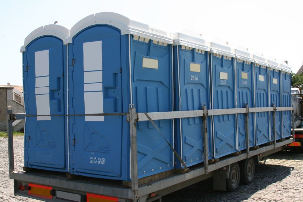 A Blue and Gray Portable Toilet is on a Trailer — Proserpine Septic Service In Proserpine, QLD