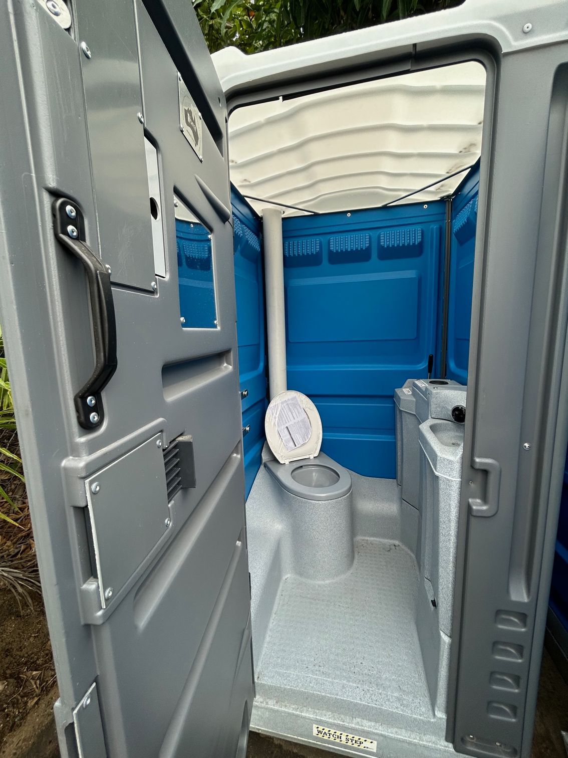 Inside Of A Blue and Gray Portable Toilet is on a Trailer — Proserpine Septic Service In Cannonvale, QLD