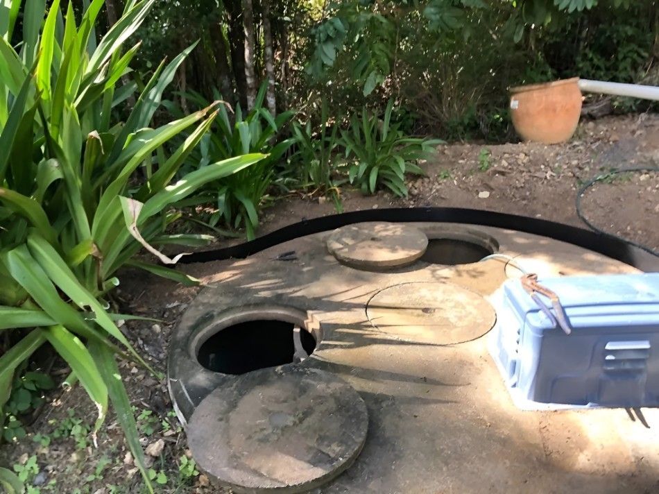 A Cooler is Sitting on the Ground Next to a Septic Tank — Proserpine Septic Service In Cannonvale, QLD