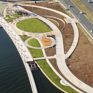 An aerial view of a park next to a body of water