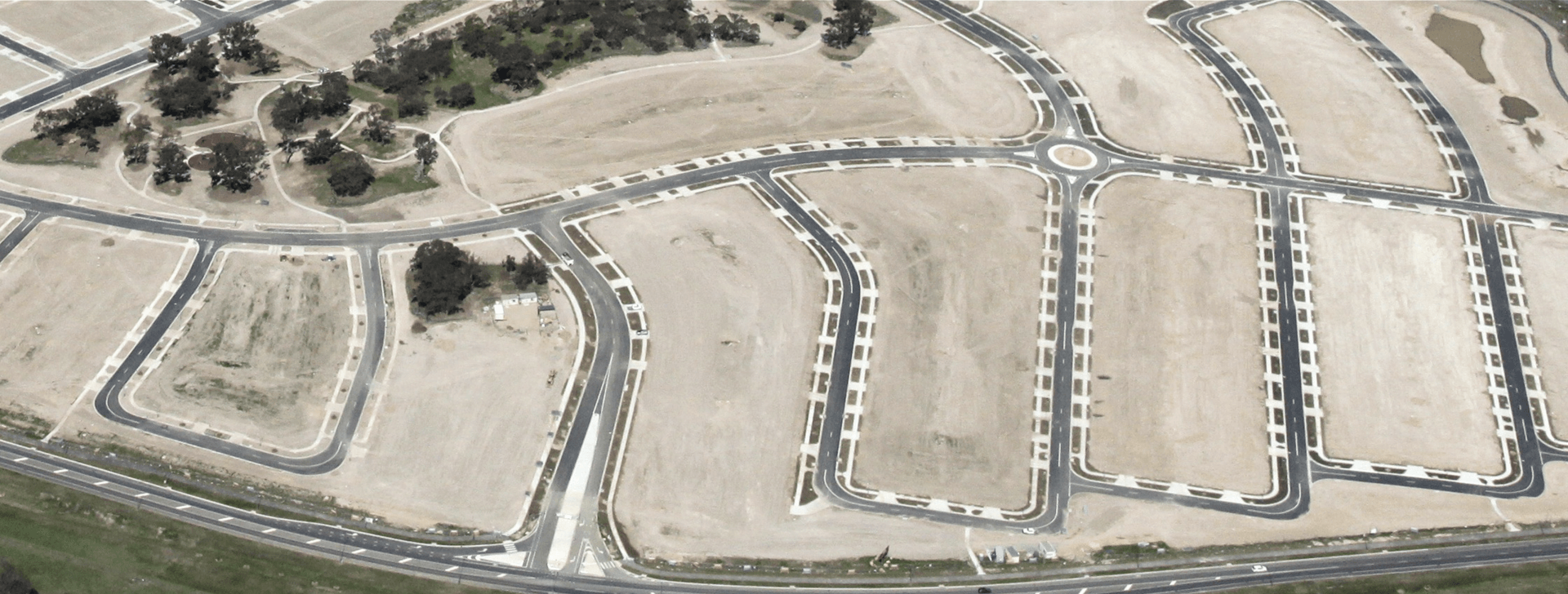 An aerial view of a residential area with lots of roads and trees.