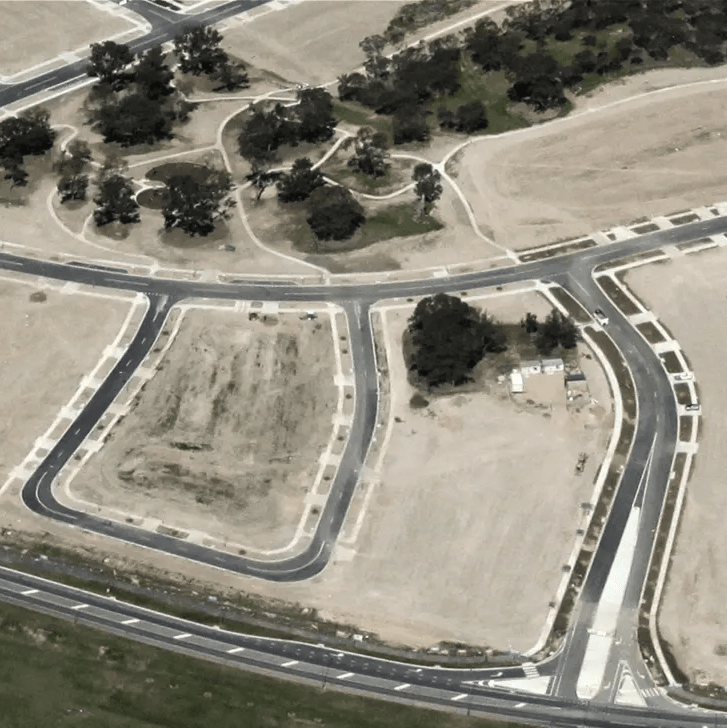 An aerial view of a residential area with lots of roads and trees