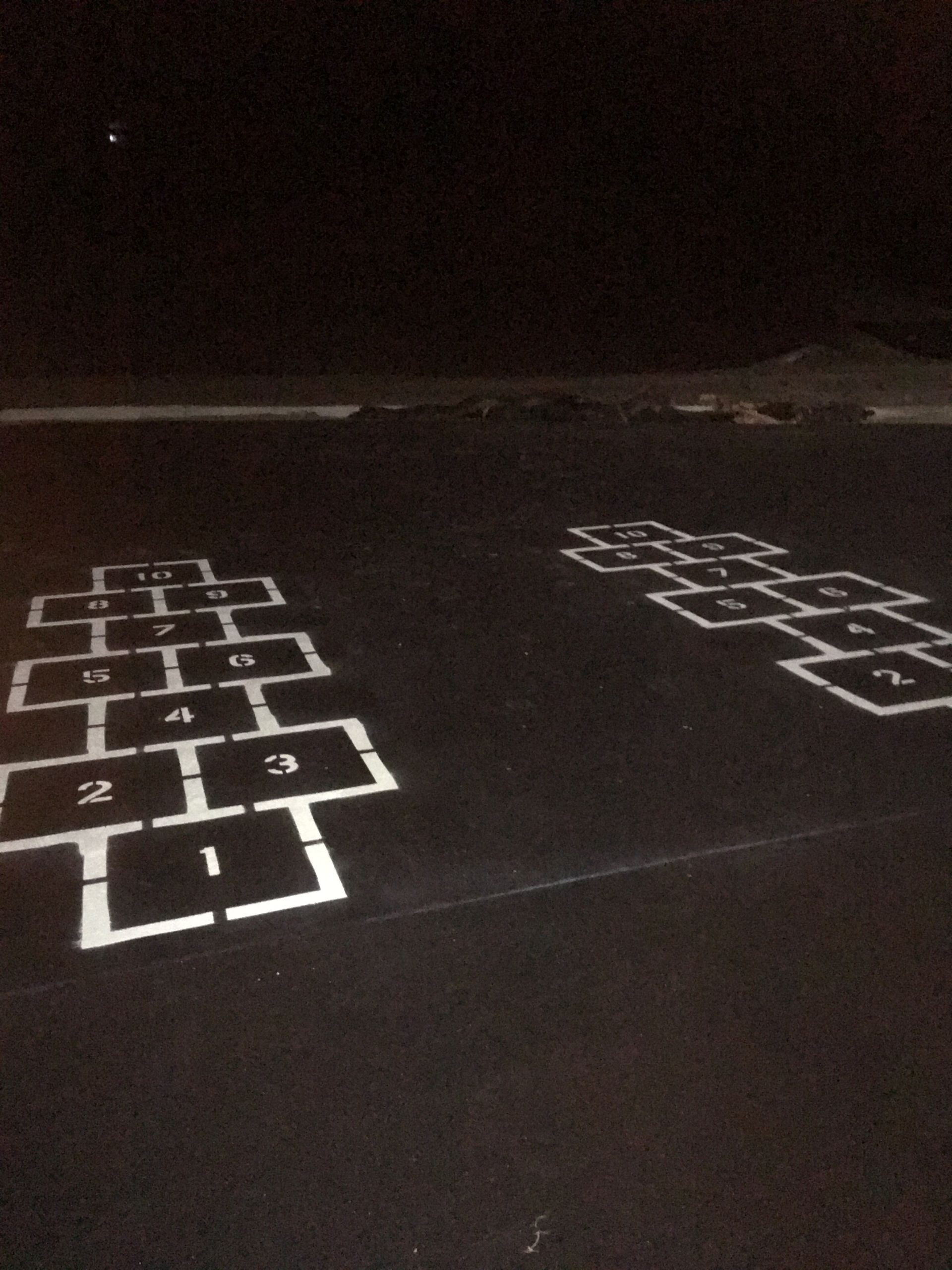 A Hopscotch Game Is Painted on The Pavement at Night | Owatonna, MN | Seykora Striping
