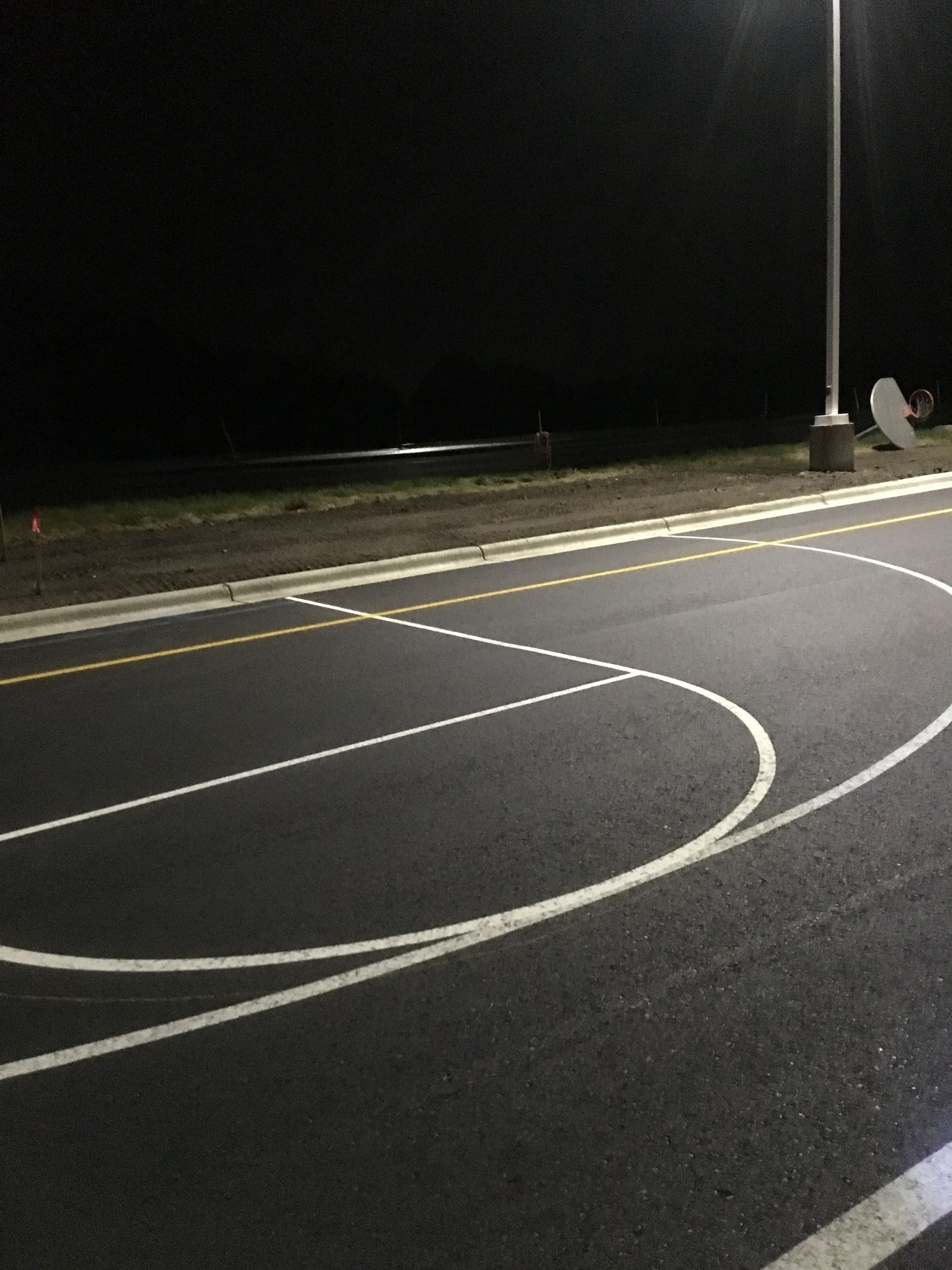 A Basketball Court Is Lit up At Night | Owatonna, MN | Seykora Striping