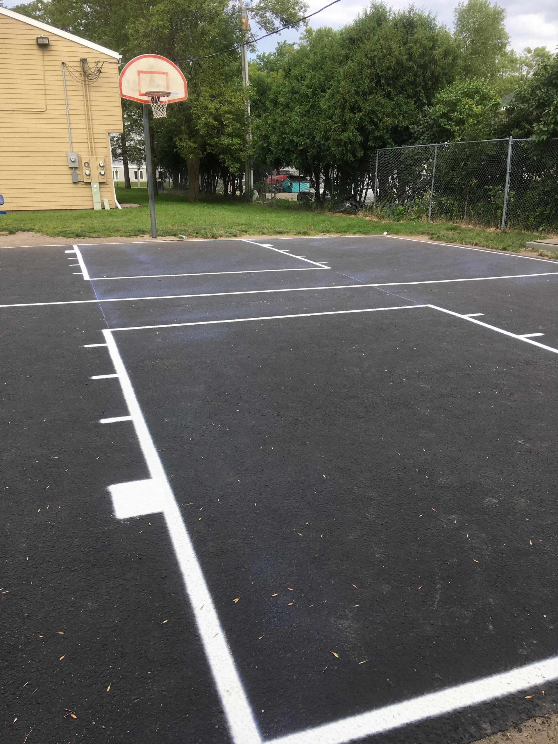 A Basketball Court with A Basketball Hoop in The Middle of It | Owatonna, MN | Seykora Striping