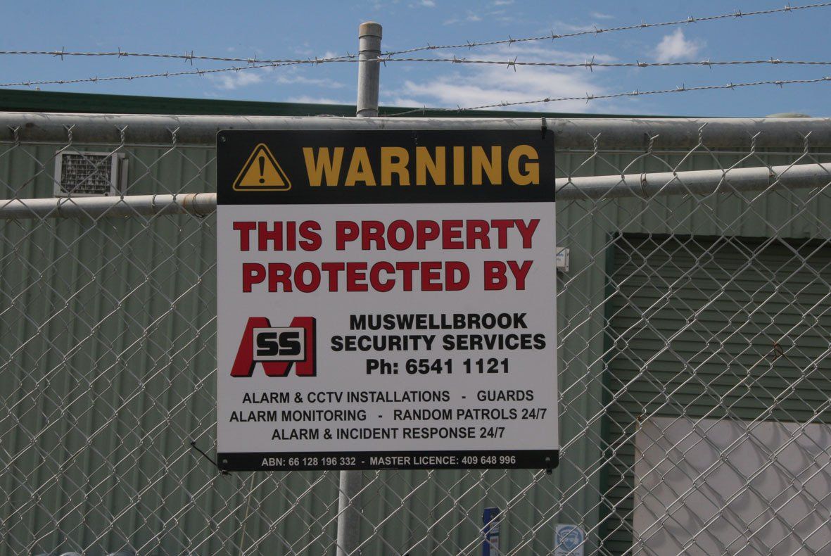 A warning sign that says this property protected by muswellbrook security services