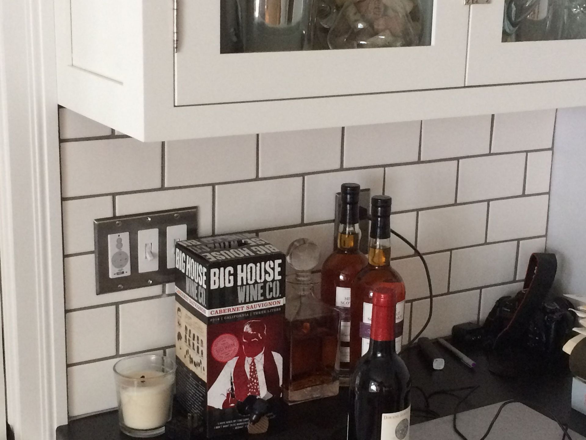 A bottle of big house wine sits on a counter