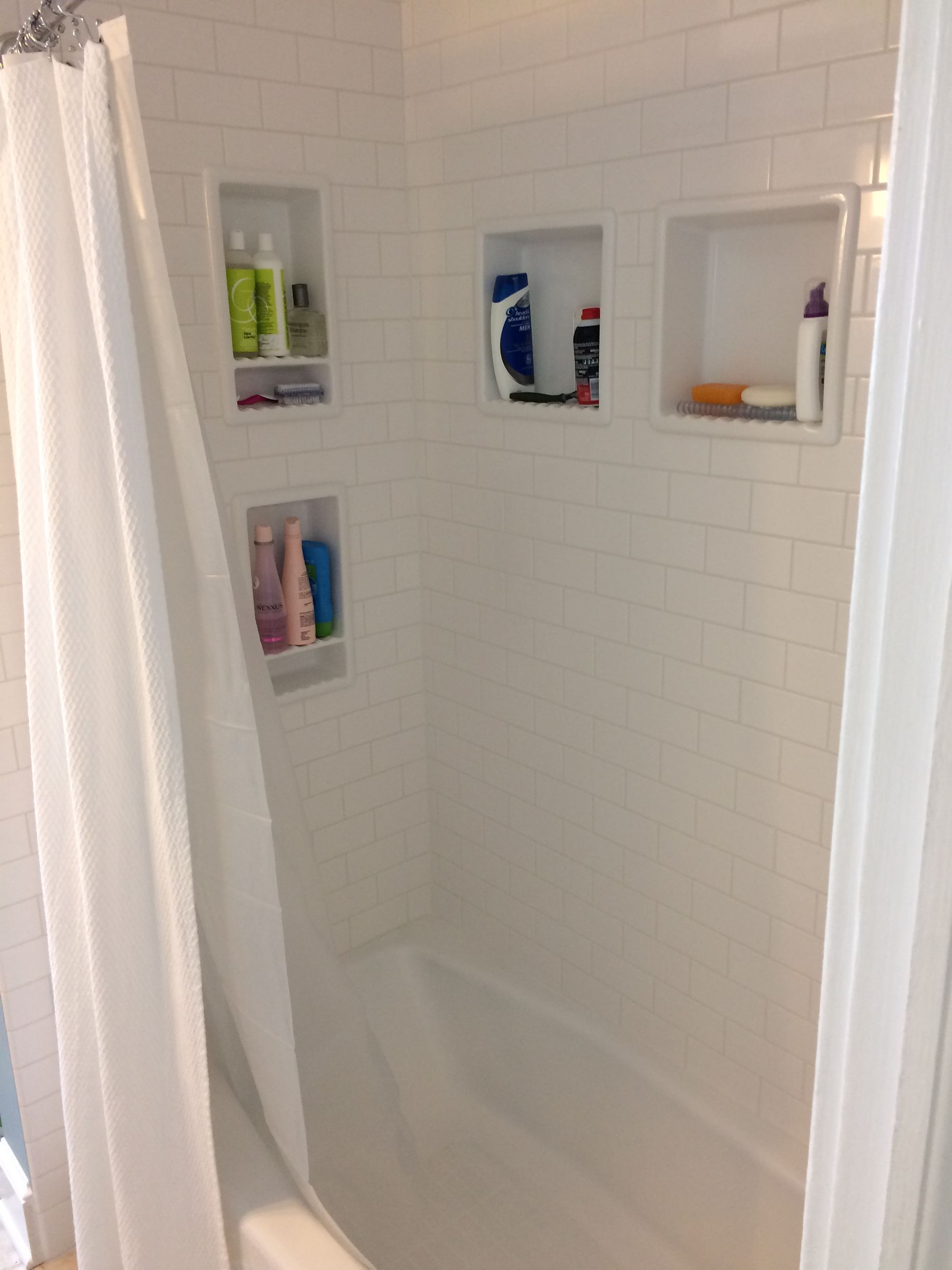 A bathroom with a shower curtain and a bathtub.