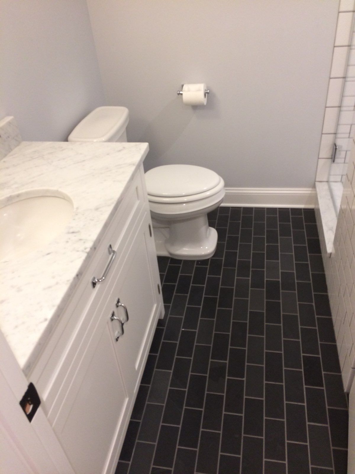 A bathroom with a toilet a sink and a shower