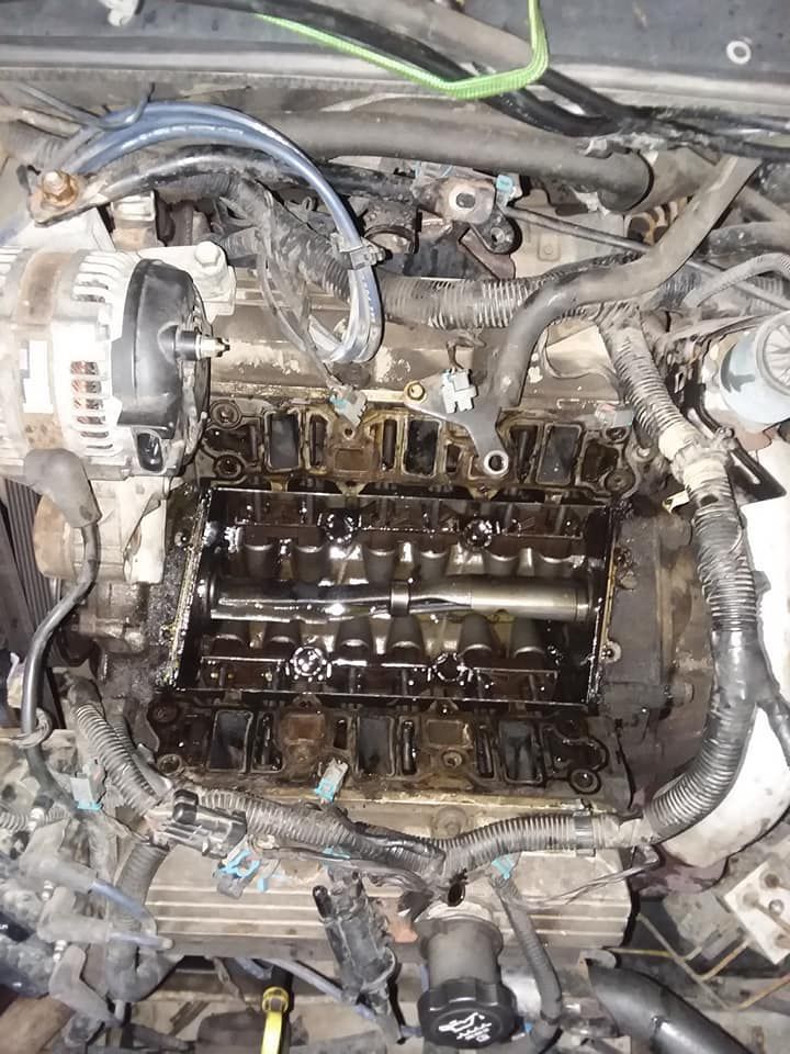 Engine bay with oil-stained components. View shows an opened engine with visible parts.