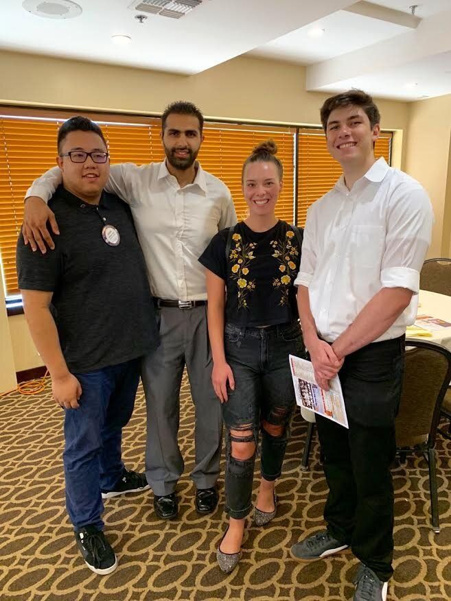 A group of people are posing for a picture in a room.
