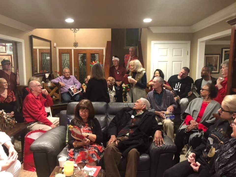 A group of people are sitting in a living room.