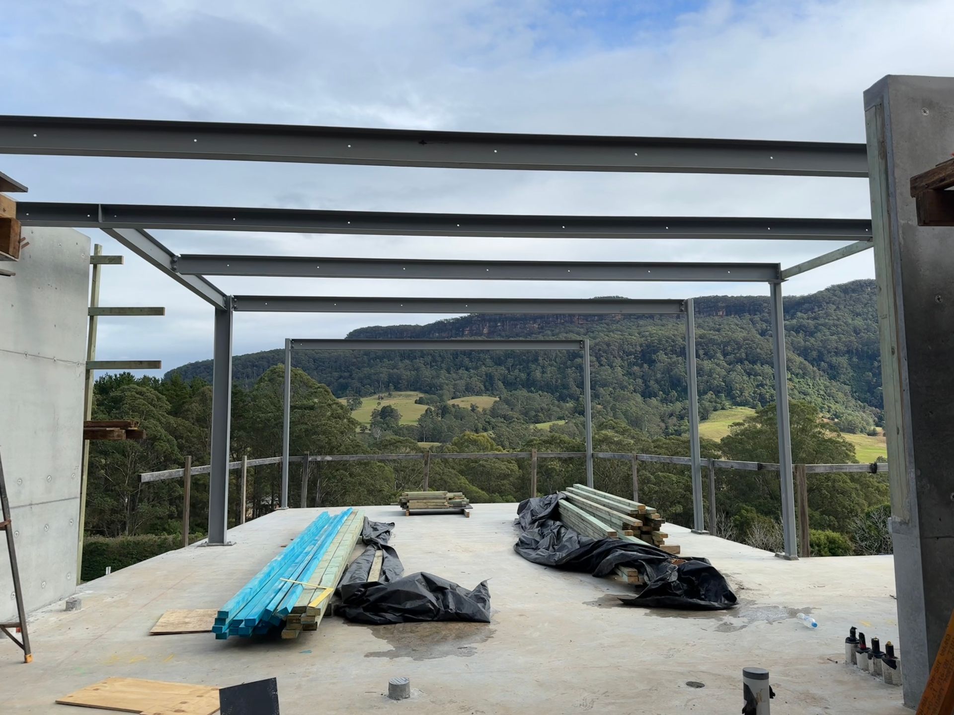 A building under construction with a view of mountains in the background