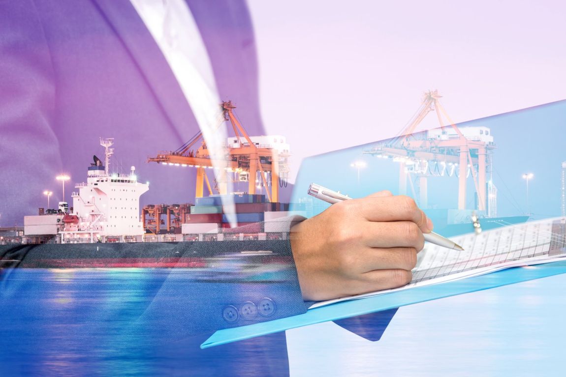 Container ship at sea super imposed over a male office worker who is dressed in a suit and writing in a notebook