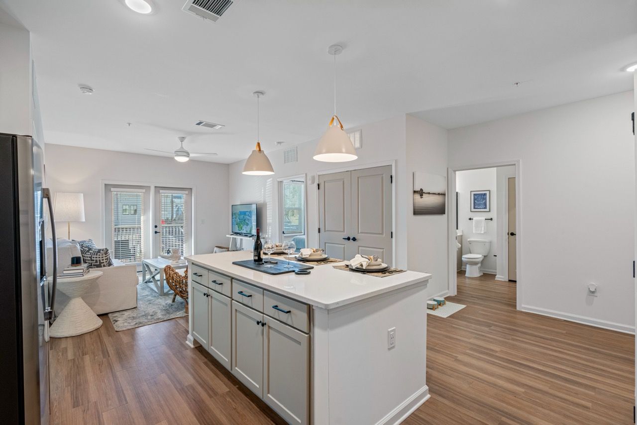 Open-concept living area with kitchen island, dining area, and seating.