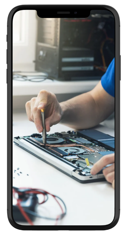 A person is using a screwdriver to fix a laptop computer.