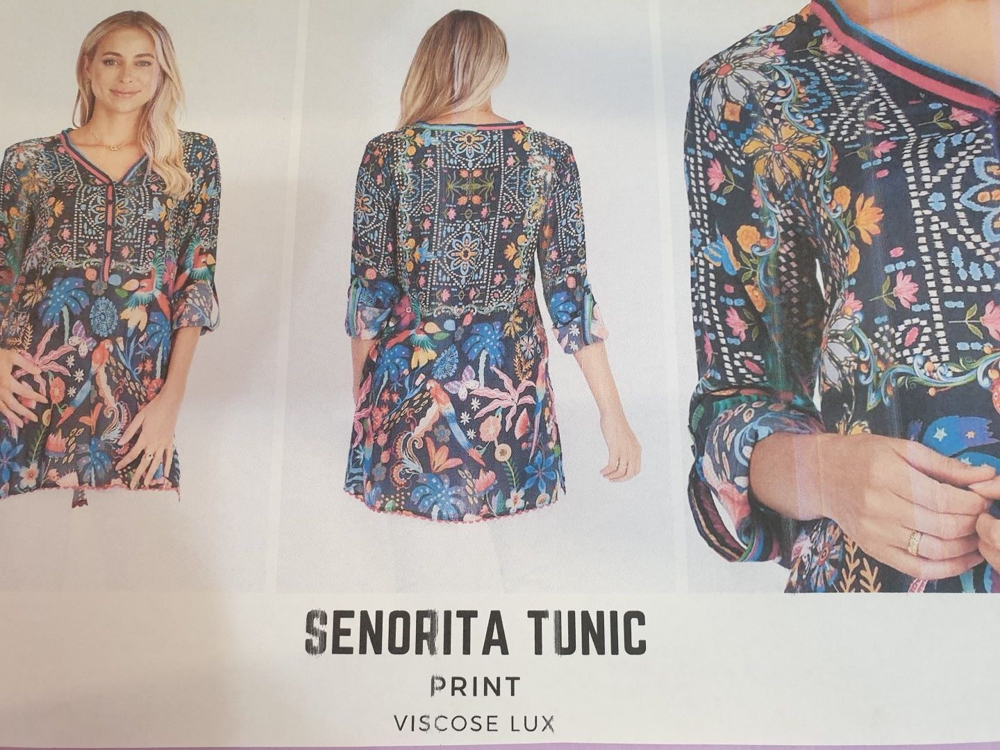 Woman modeling a floral print Senorita tunic. Front and back views, dark background with blue, yellow and pink floral pattern.