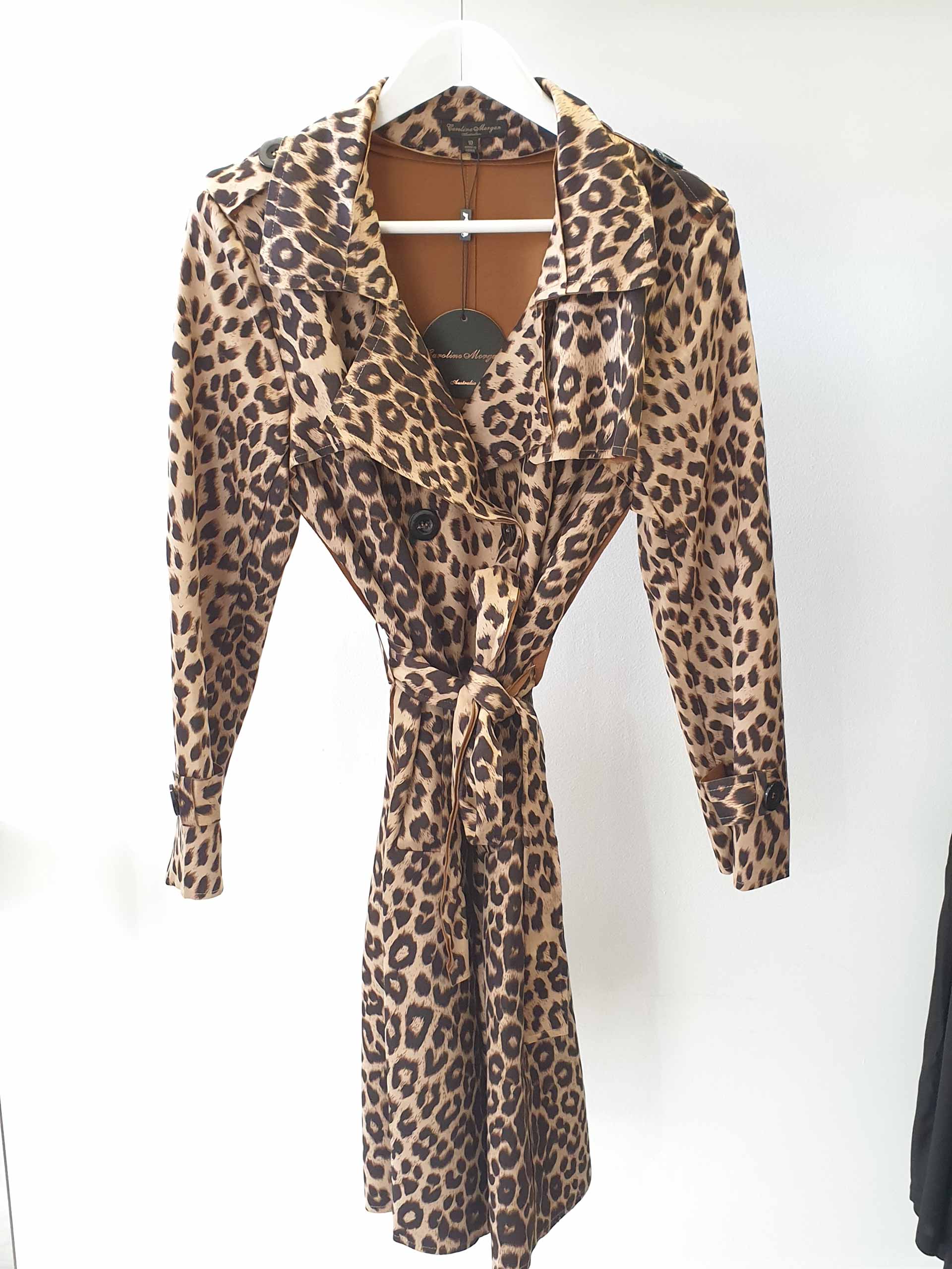 Leopard print belted dress hanging on a white hanger.