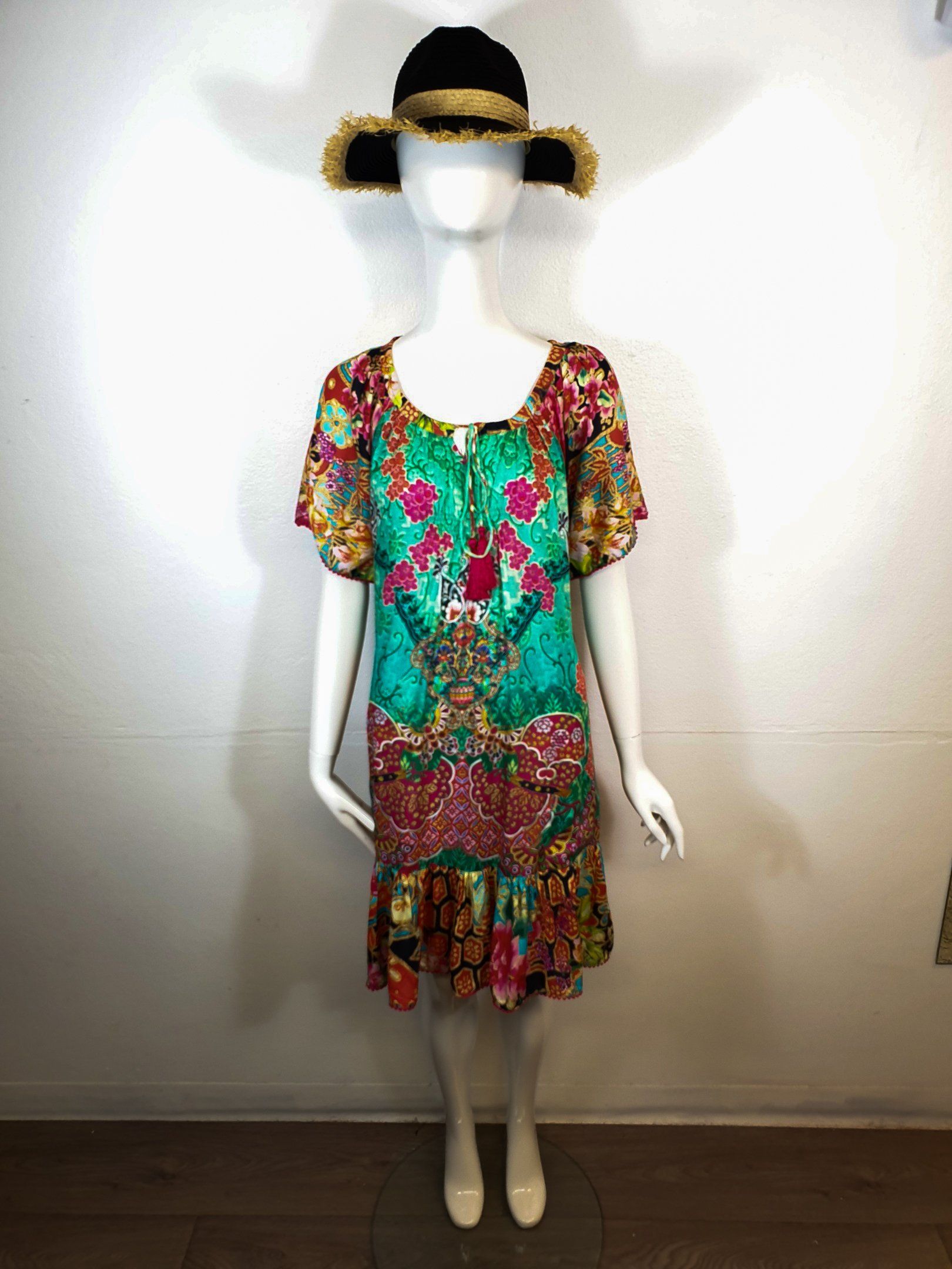 Mannequin in colorful floral dress and fur hat against white wall.