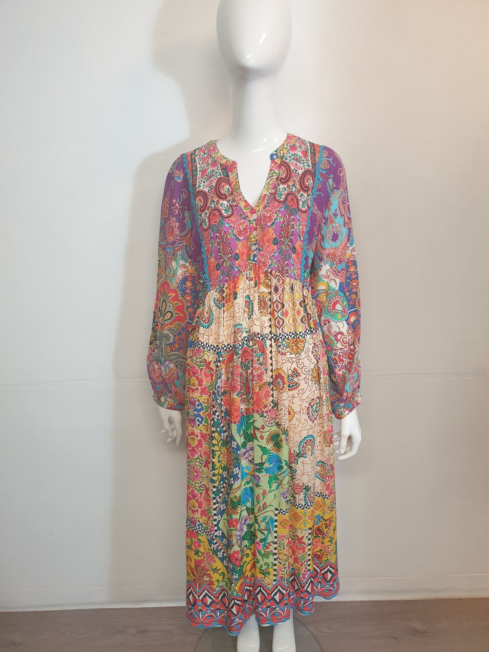 Colorful floral print dress on a mannequin.