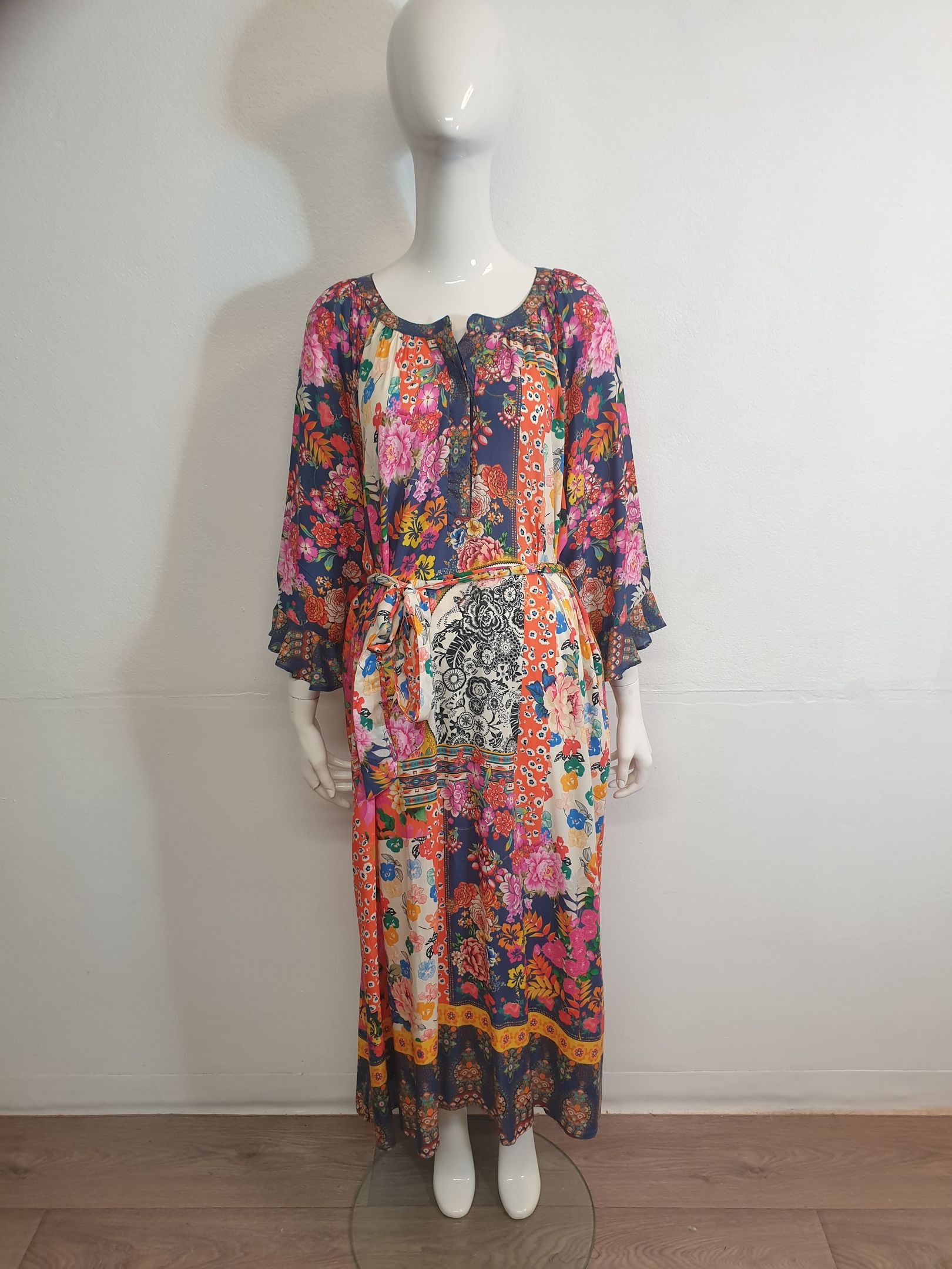 Mannequin wearing a long floral print dress with long sleeves and a high neckline.