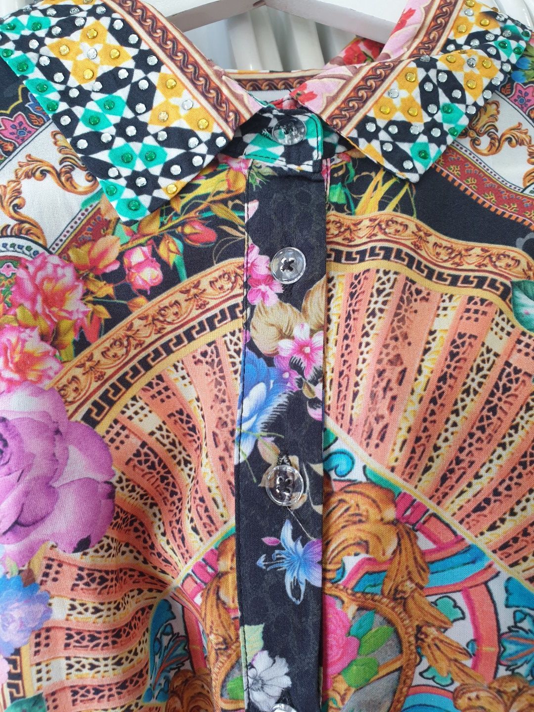 Colorful floral and ornate print shirt with a patterned collar.