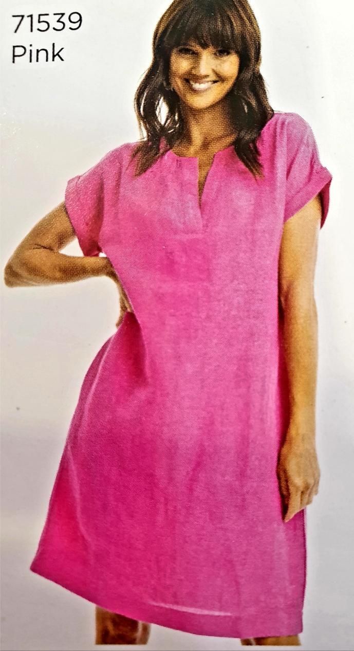 Woman wearing a pink dress with a keyhole neckline and short sleeves.