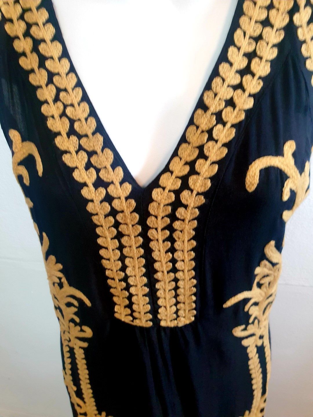 Navy dress with gold embroidery around the V-neckline and down the front.