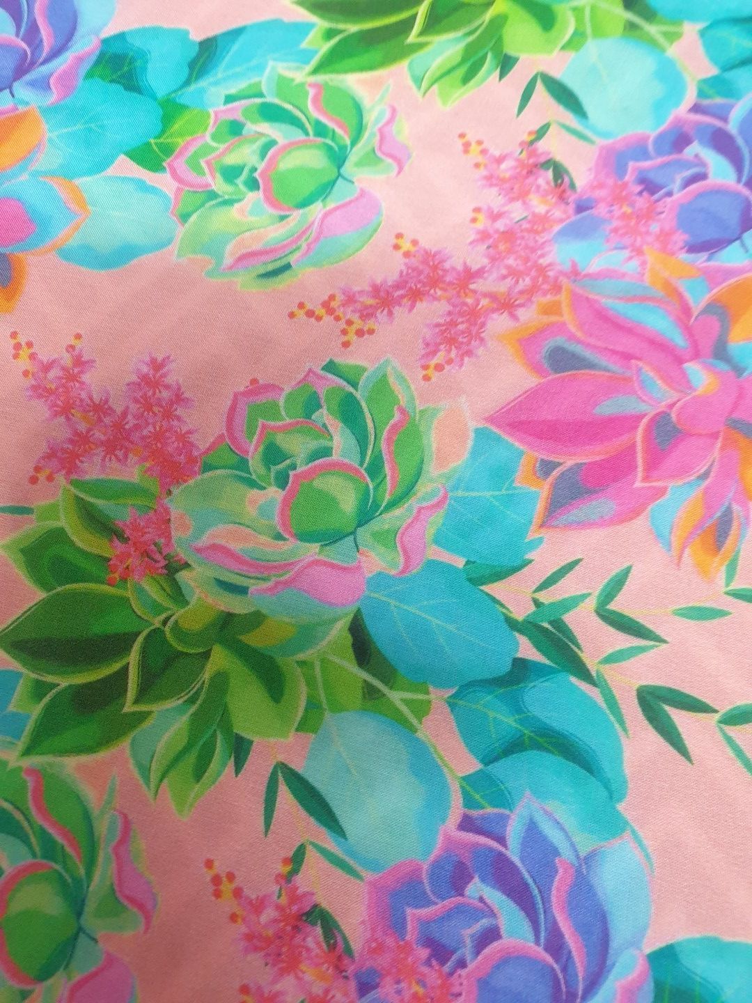 Colorful floral fabric with teal, pink, and purple succulents on a pale pink background.