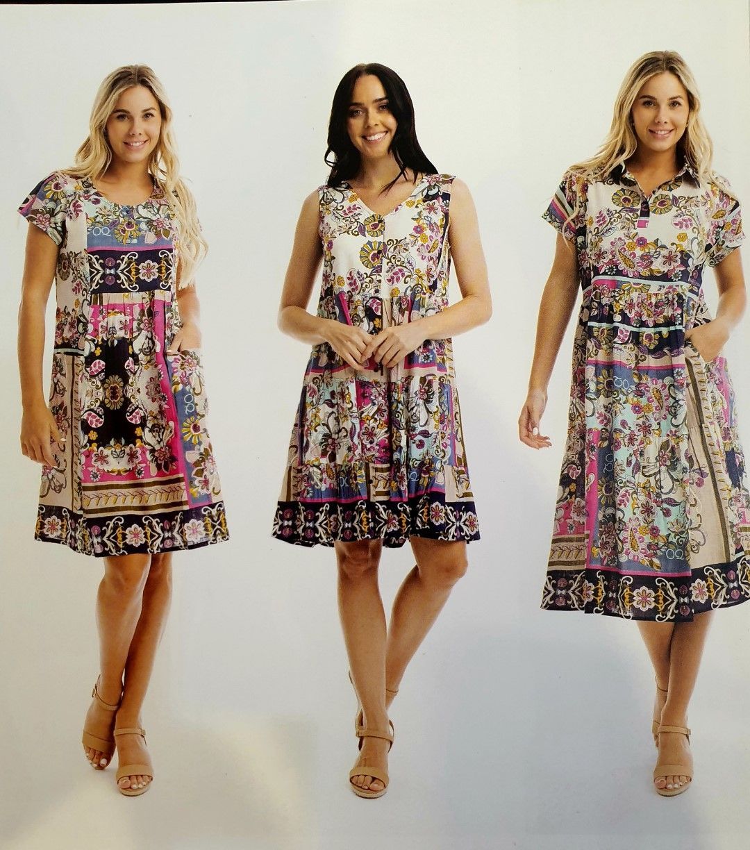 Three women wearing patterned dresses, standing against a white background.