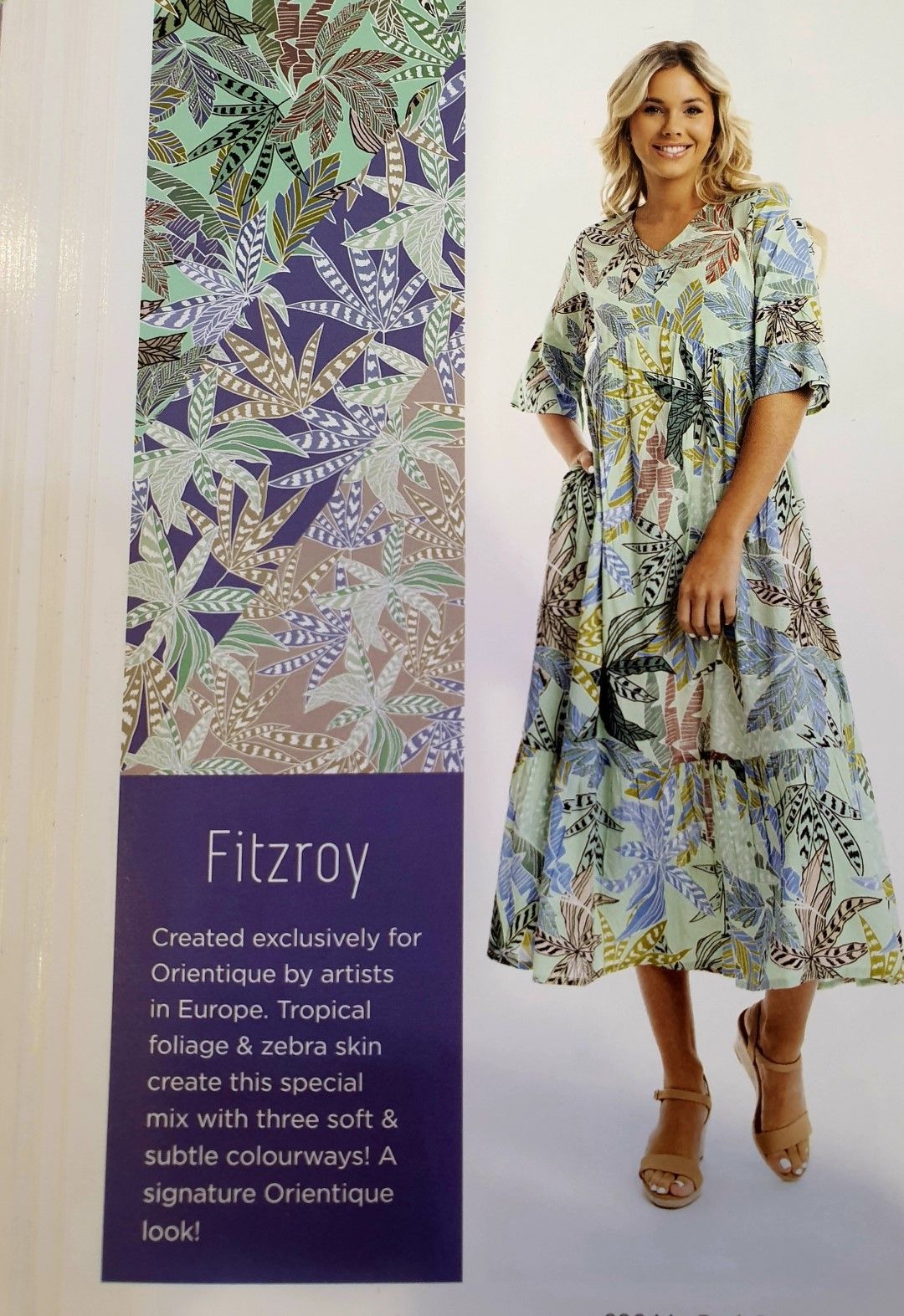 Woman in a floral print dress, posing. Beside it, a fabric swatch. 