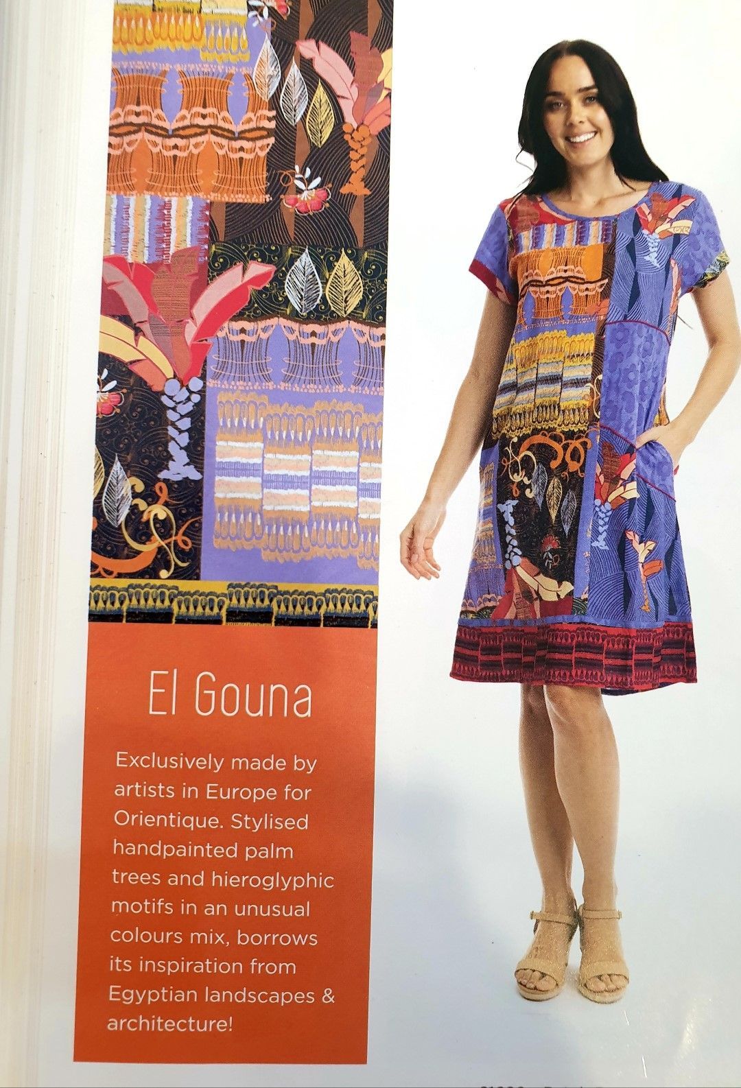 Woman wearing a colorful, patterned dress, standing next to a fabric sample featuring an Egyptian motif.