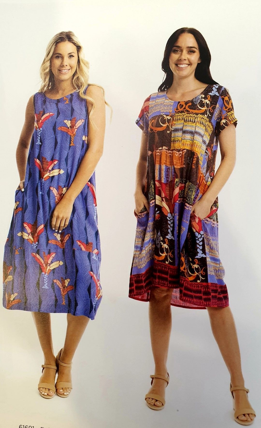Two women in dresses. One blue with birds, one print. Both wear sandals, smiling, pockets.