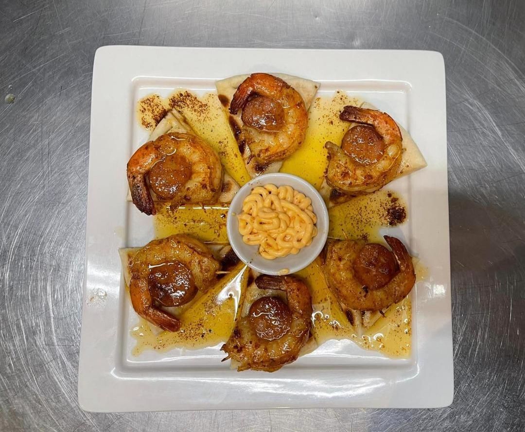 A White Plate Topped With Shrimp And A Small Bowl Of Sauce — Zeus's Bar & Grill In Tullimbar, NSW