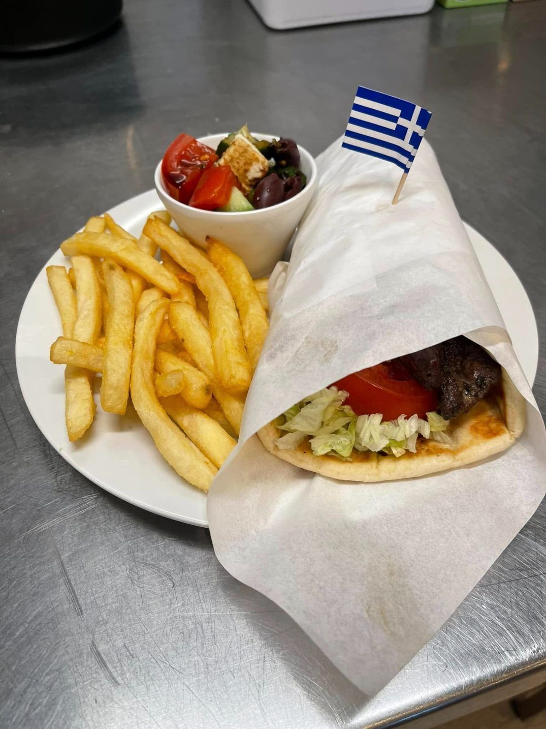 A Plate Of Gyro And French Fries On A Table — Zeus's Bar & Grill In Tullimbar, NSW
