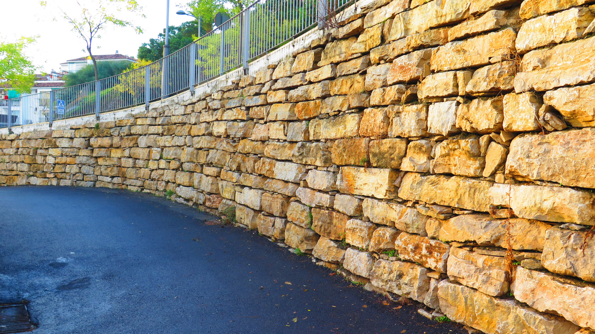 Stone fireplace with wood-burning stove and black chimney, decorated with rustic accents.
