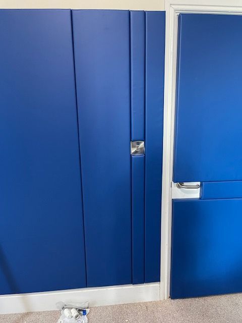 Peter Padding padded door and wall with padding around light fitting