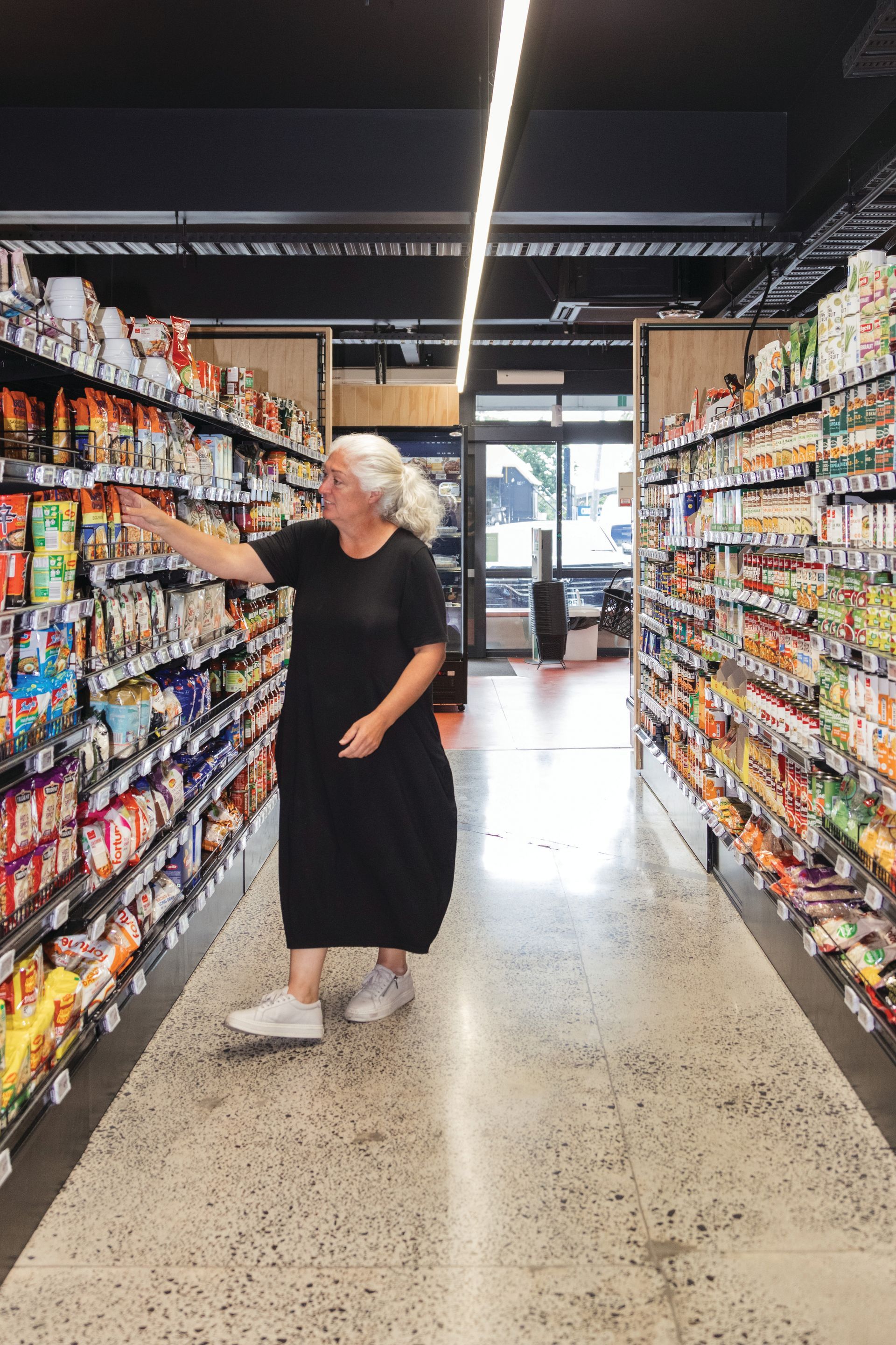 A woman is shopping in a grocery store.