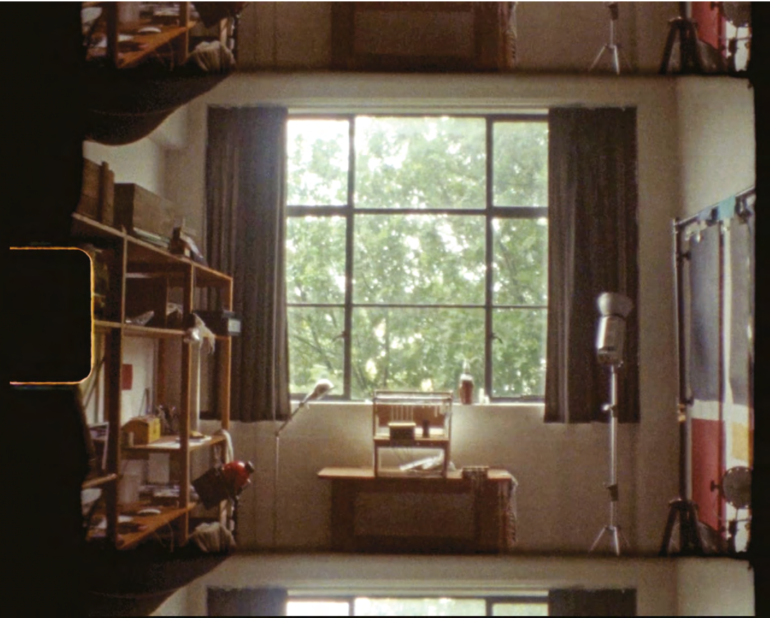 A room with a large window and a desk.