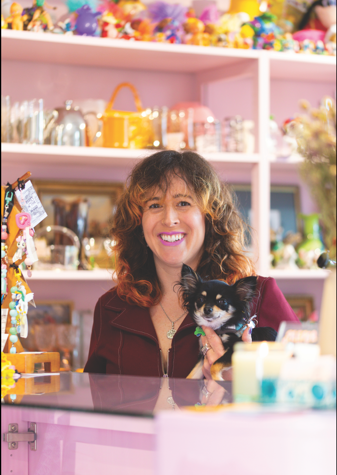 A white dome rood of a building with a red flag on top of it.