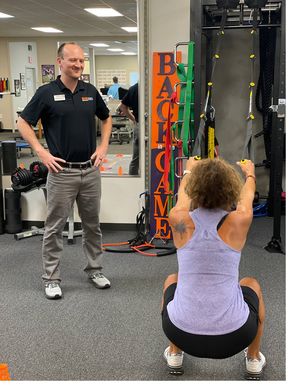 Back in the Game physical therapist watching a patient and coaching her through musculoskeletal therapy