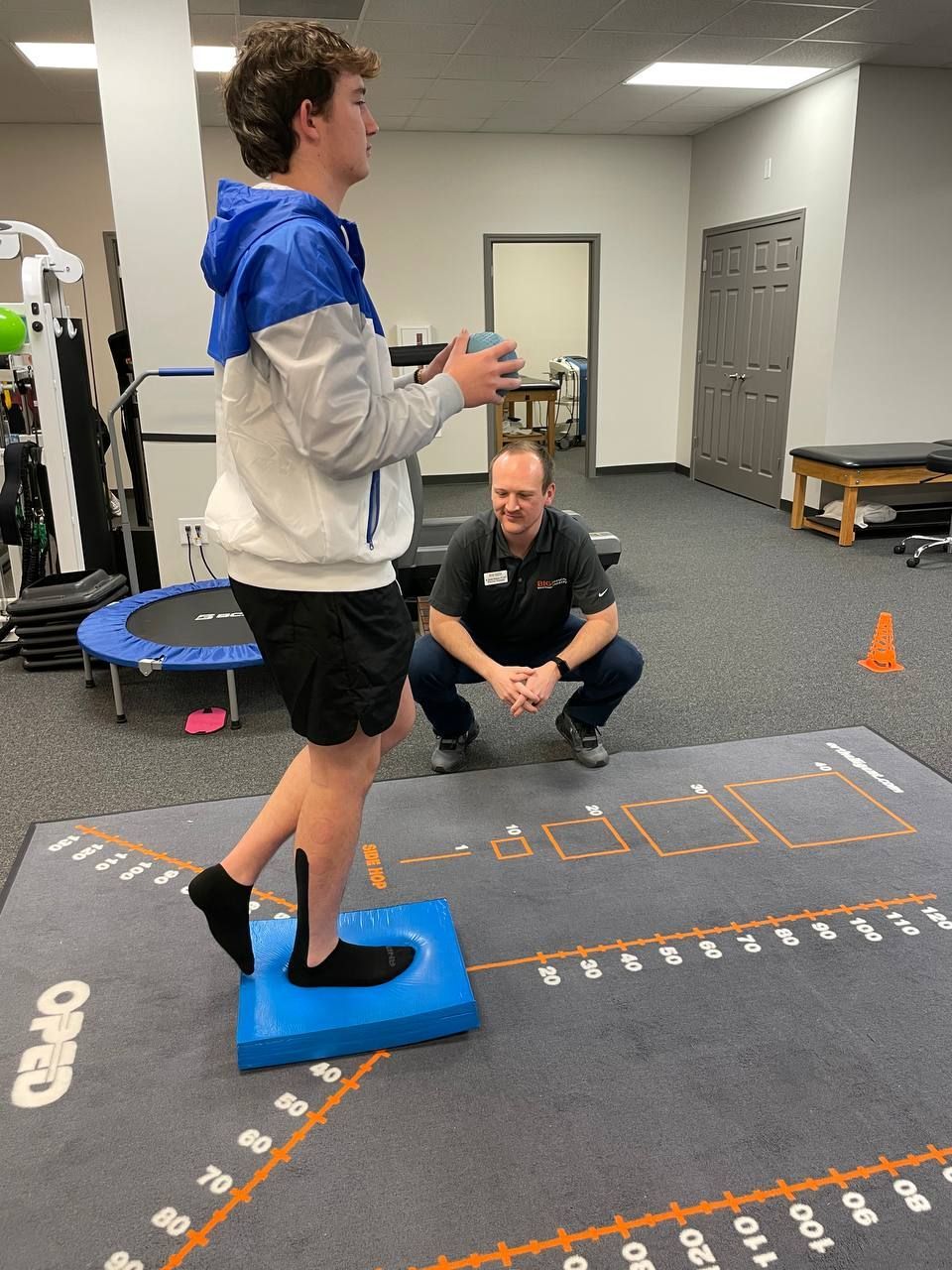 Physical Therapist Austin Pearson guiding a patient through an exercise 