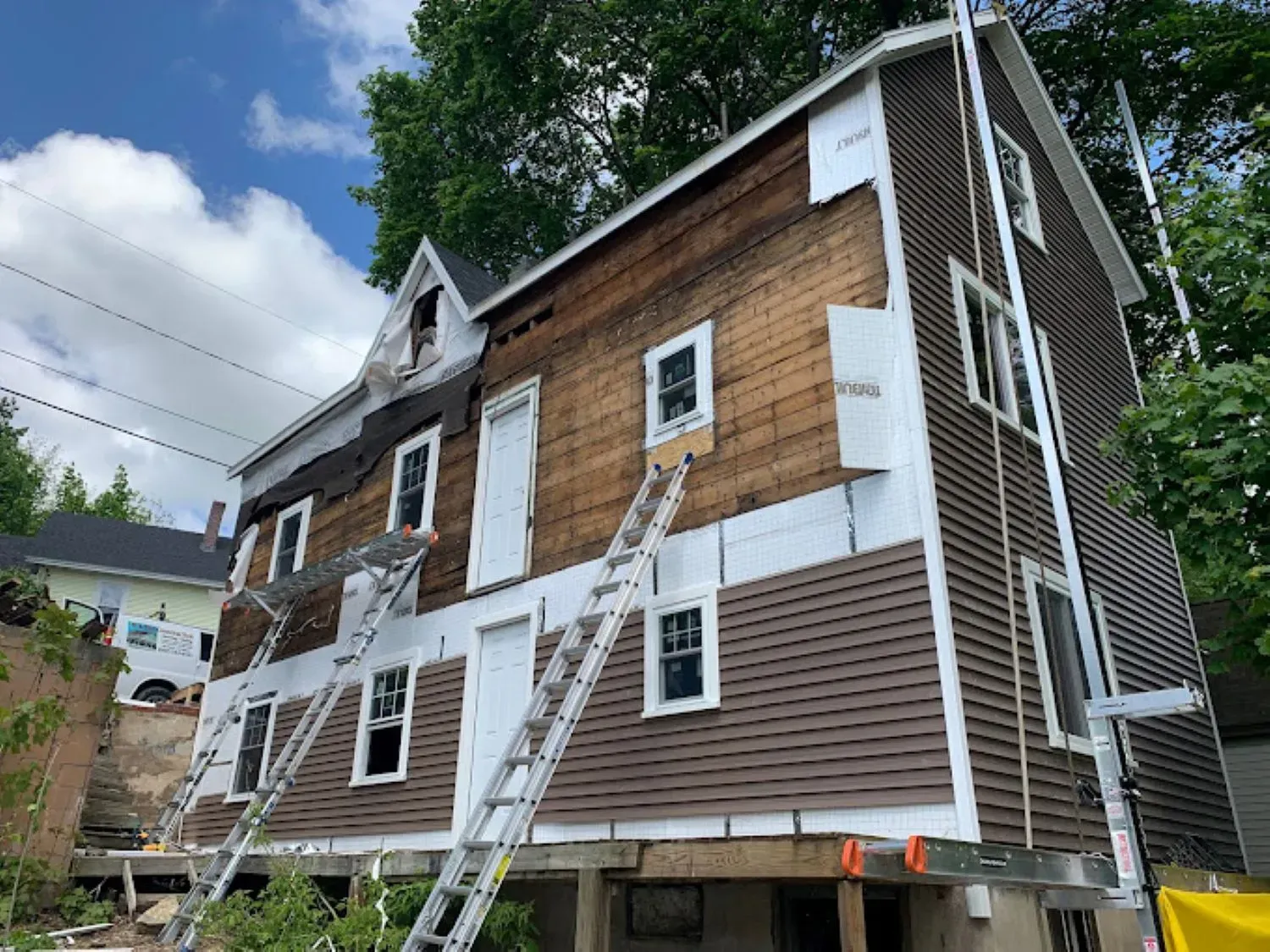A large house with a lot of windows is being remodeled.