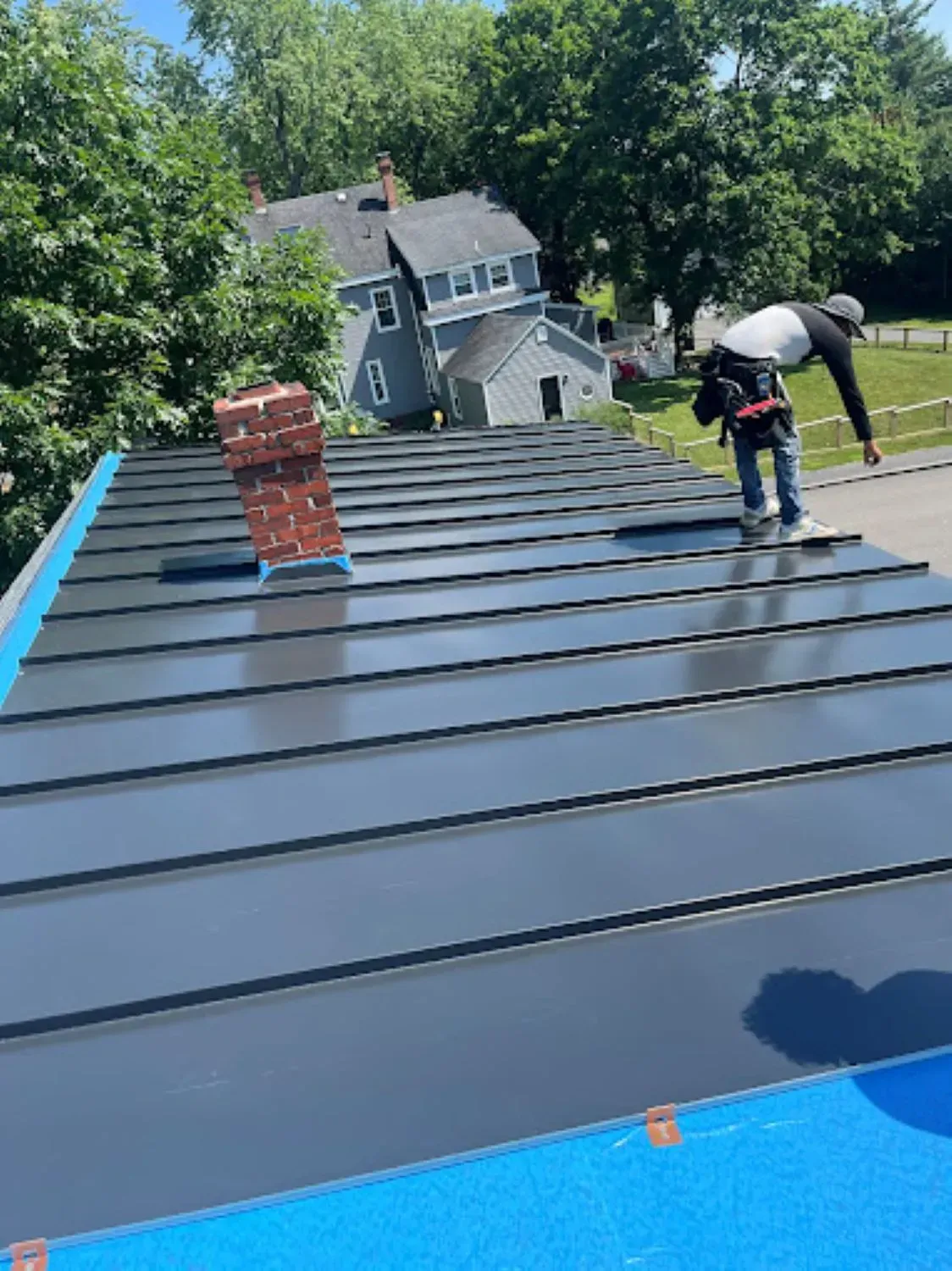 A man is standing on top of a roof.