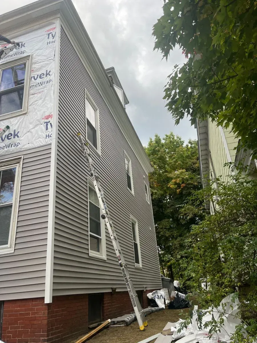A ladder is leaning against the side of a house.