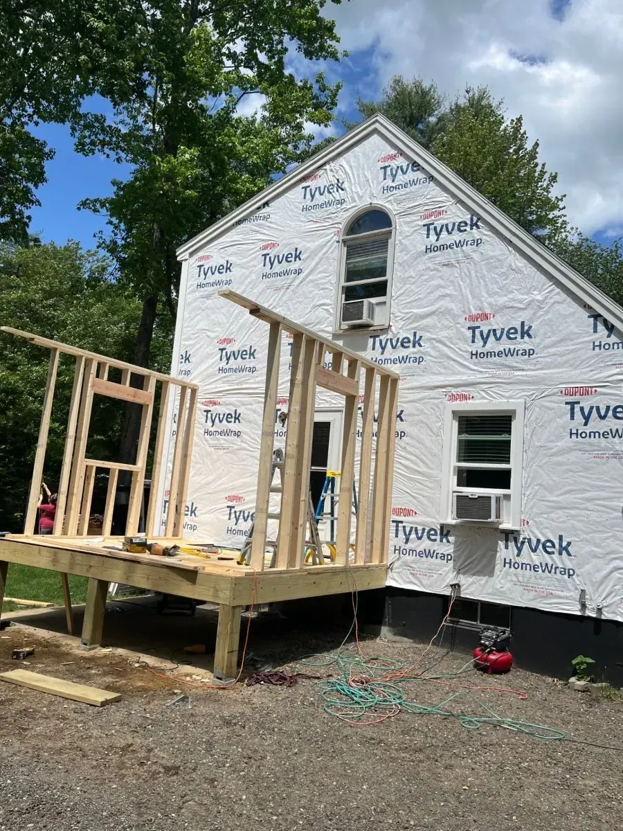 A house is being built with a deck attached to it.