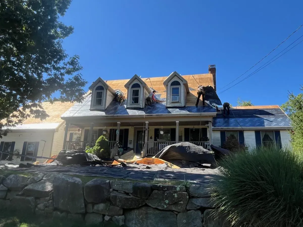 A large house with a roof that is being installed.